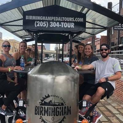 Group of people sitting on party pedal bike