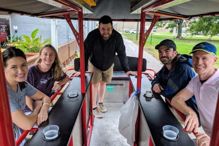 Inside photo of a party pedal bike with riders