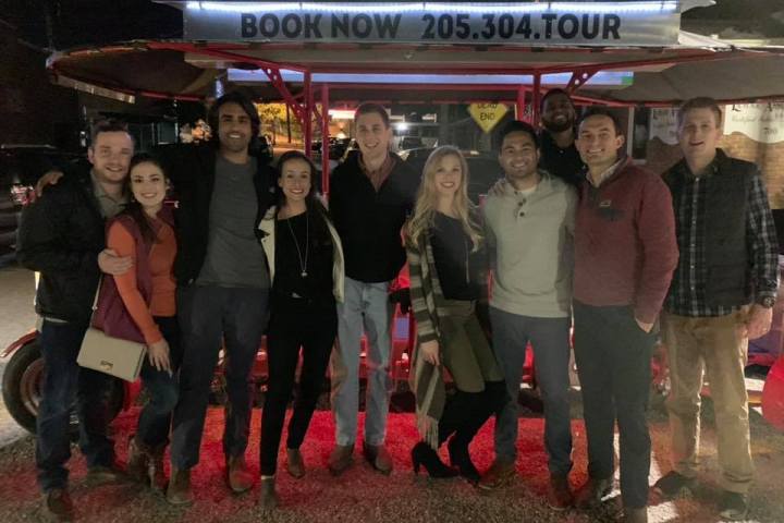Group of party pedal bike bikers standing in front of their party bike