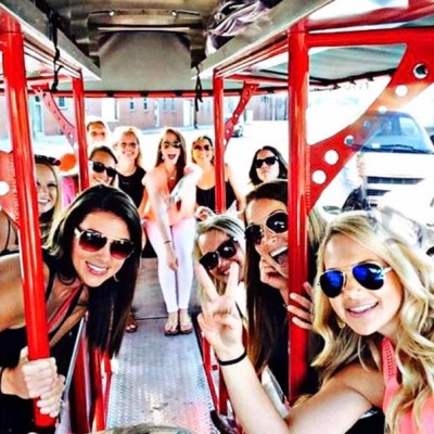 Group of people pedaling bar bike